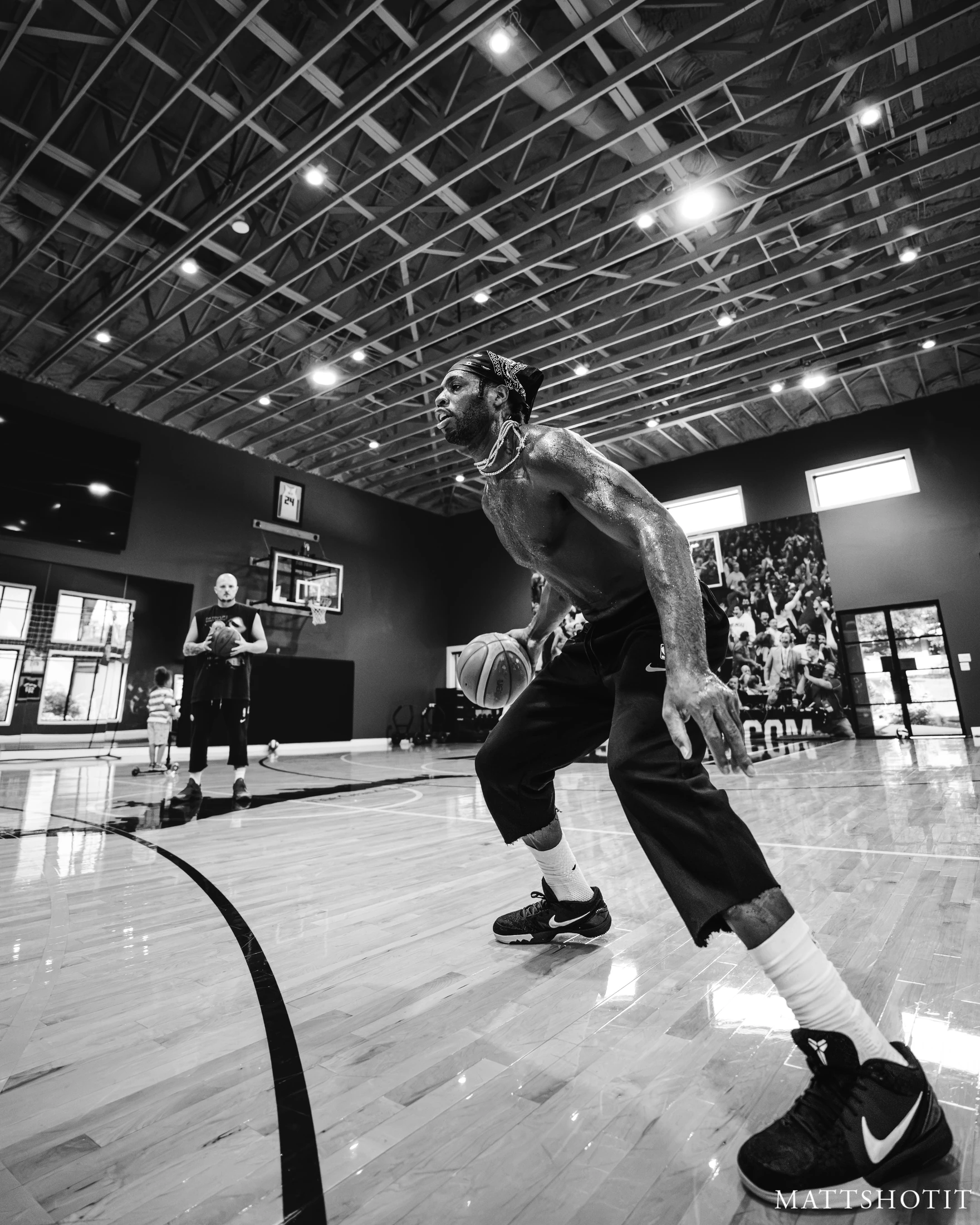 Buddy Hield drives with the basketball while Trey Slate watches from behind. Photograph by MATTSHOTIT.